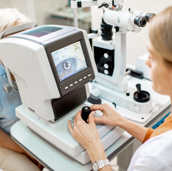 Ophthalmologist examining eyes with digital microscope